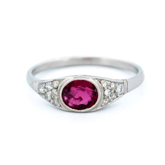 An oval ruby ring with diamond shoulders in platinum