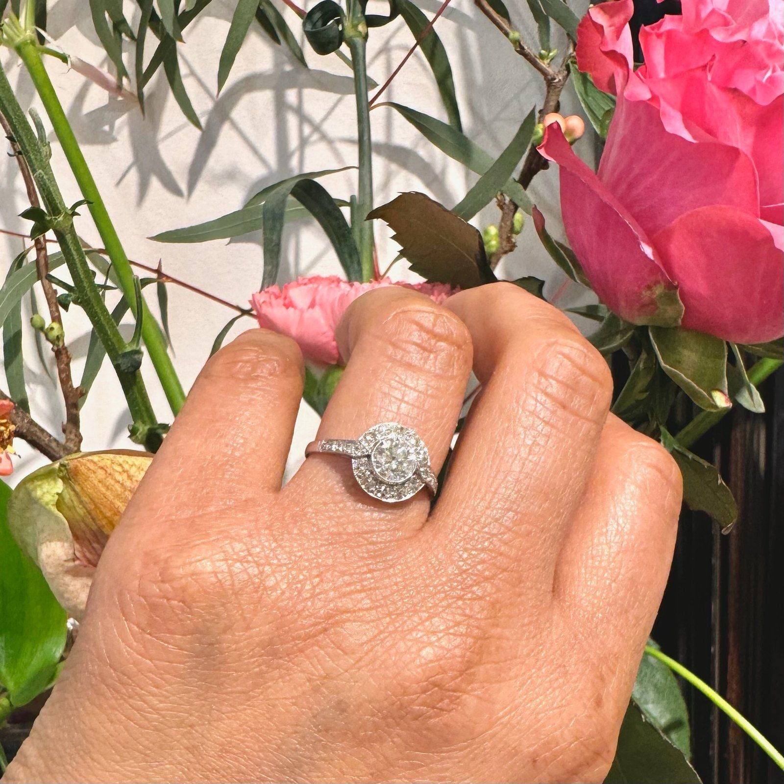 A halo target cluster ring set with diamonds in platinum, modelled on a hand