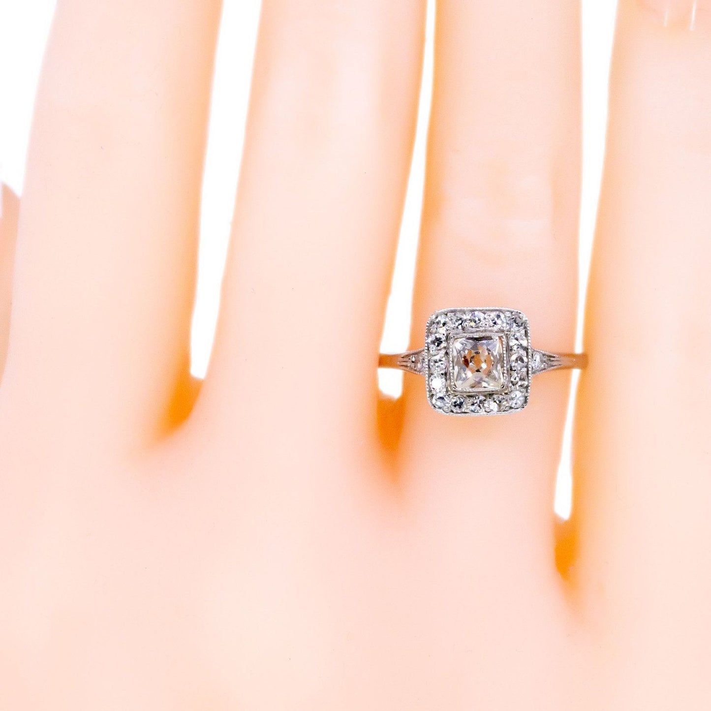 A square shaped diamond cluster ring in platinum, modelled on a hand
