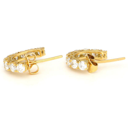 A pair of brilliant cut diamond half hoop earrings in yellow gold