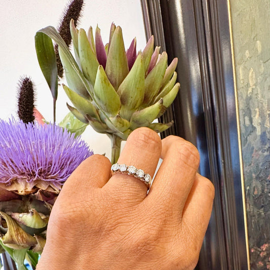 A five stone diamond ring in yellow and white gold, modelled on a hand