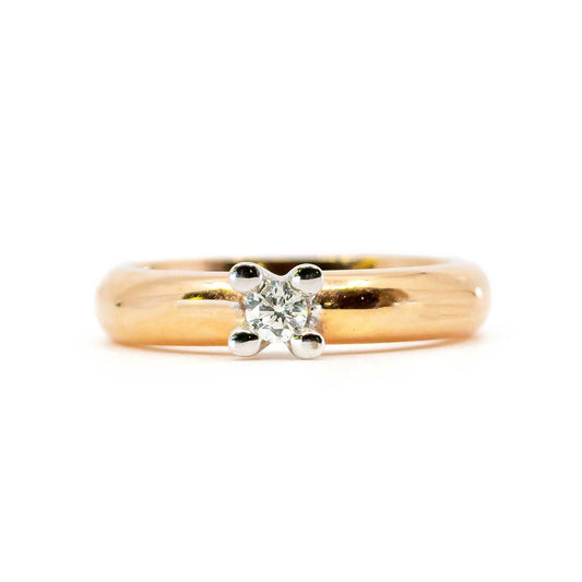 A single stone diamond ring in yellow and white gold