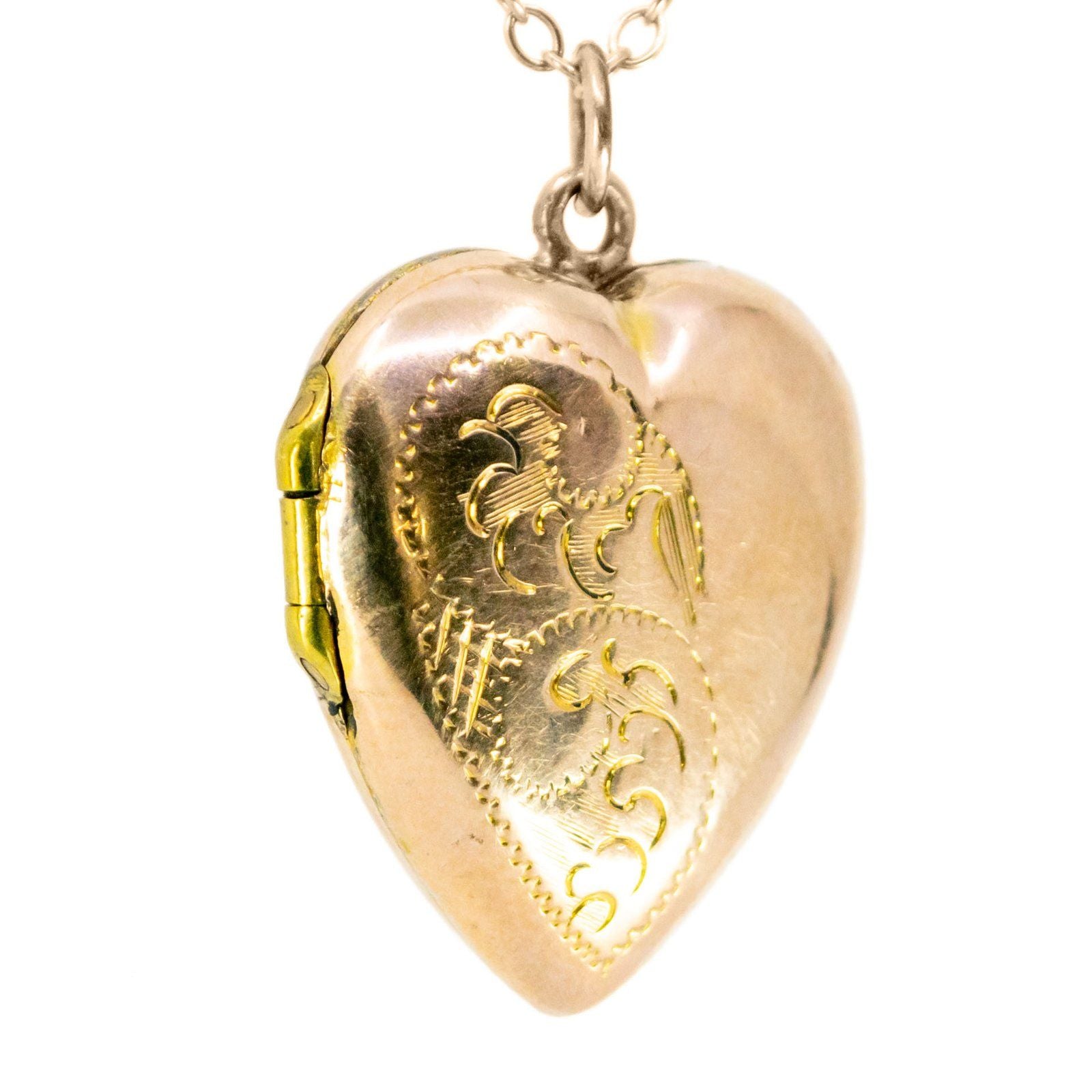 A yellow gold heart shaped locket, with a chain
