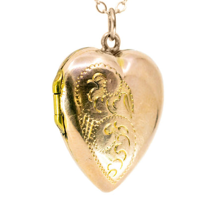 A yellow gold heart shaped locket, with a chain