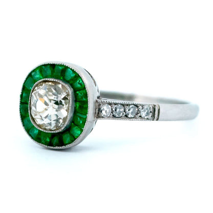An emerald and diamond halo target cluster ring in platinum