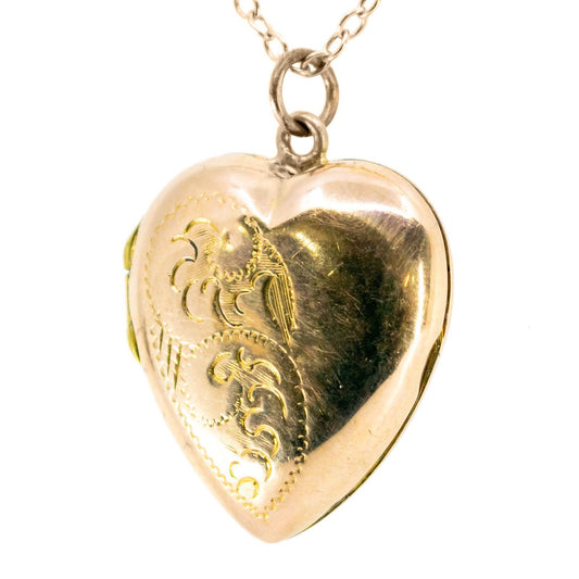 A yellow gold heart shaped locket, with a chain