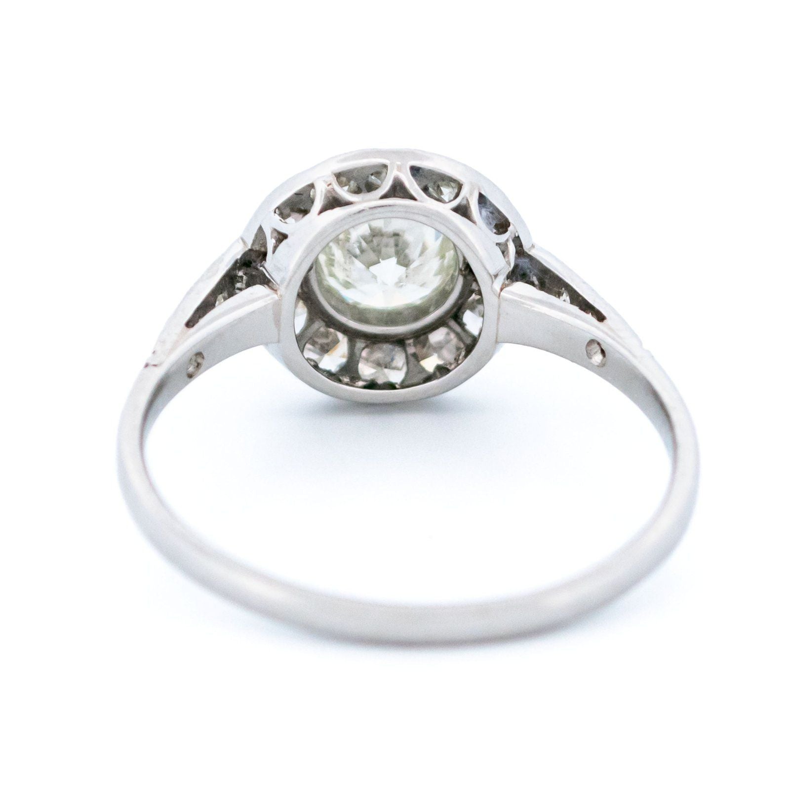 A halo target cluster ring set with diamonds in platinum