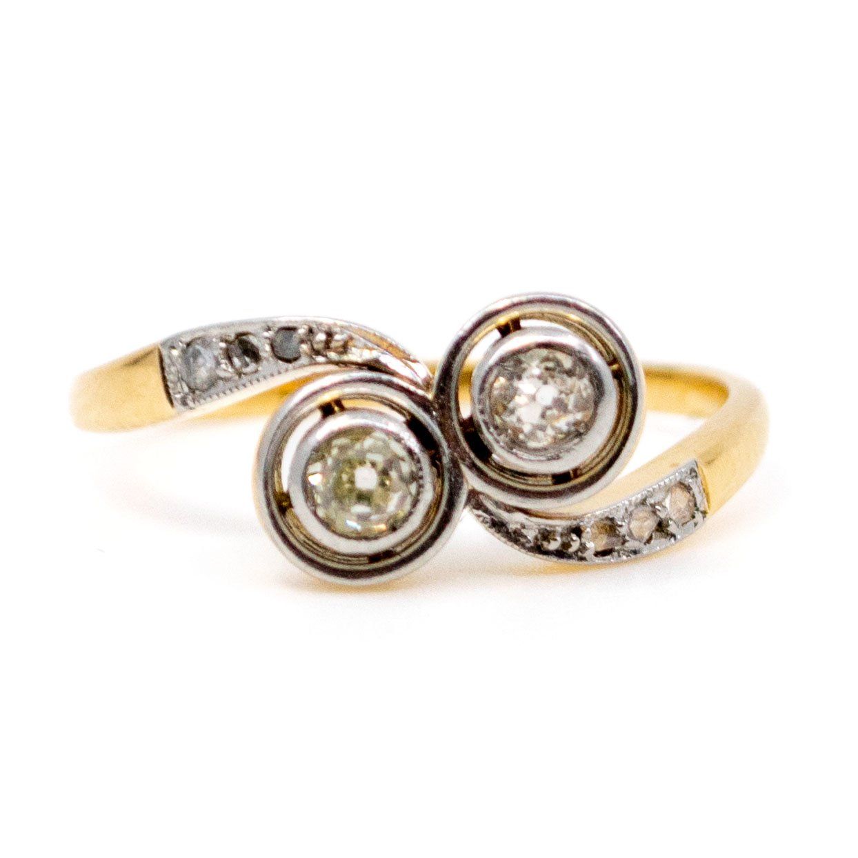 A two stone diamond crossover ring in yellow and white gold