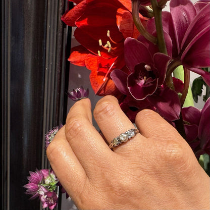 A yellow gold and silver rose cut diamond three stone ring, modelled on a hand