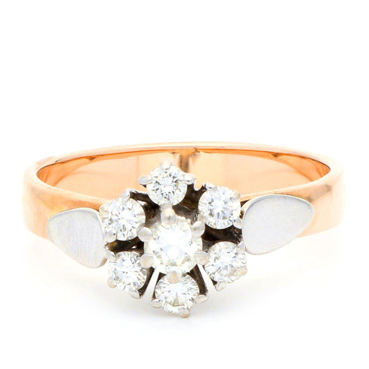 A diamond cluster ring in rose and white gold