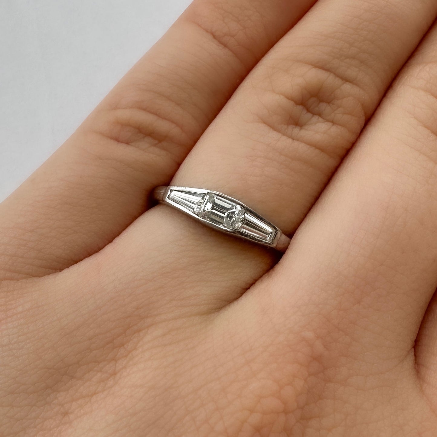 Vintage Emerald and Tapered Baguette Diamond Three Stone Engagement Ring in Platinum