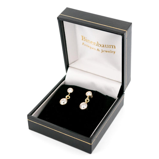 A pair of yellow gold two stone old cut diamond drop earrings, in an earring box