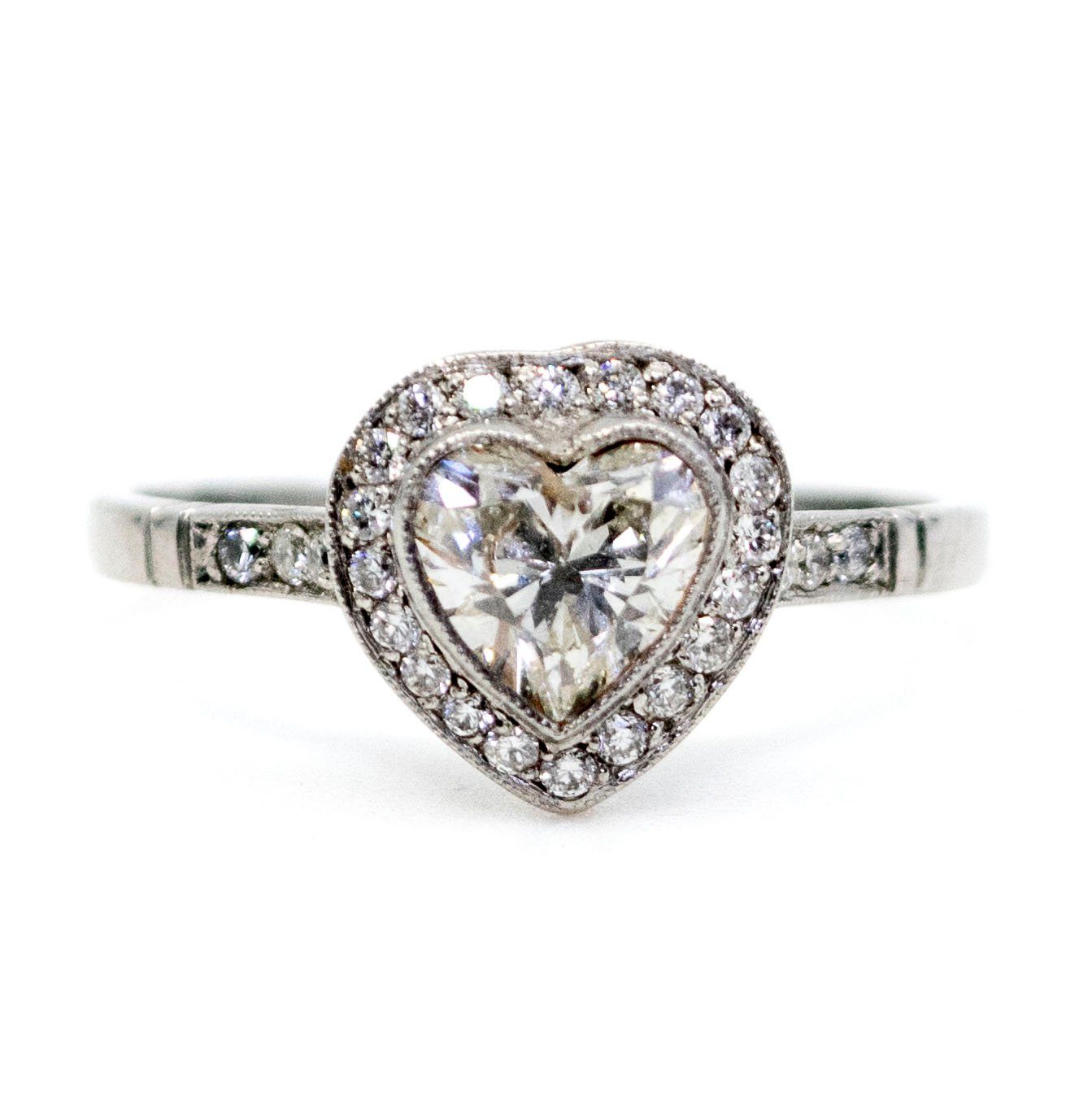 A heart shaped diamond cluster ring in platinum, with diamond shoulders