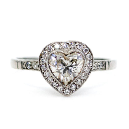 A heart shaped diamond cluster ring in platinum, with diamond shoulders