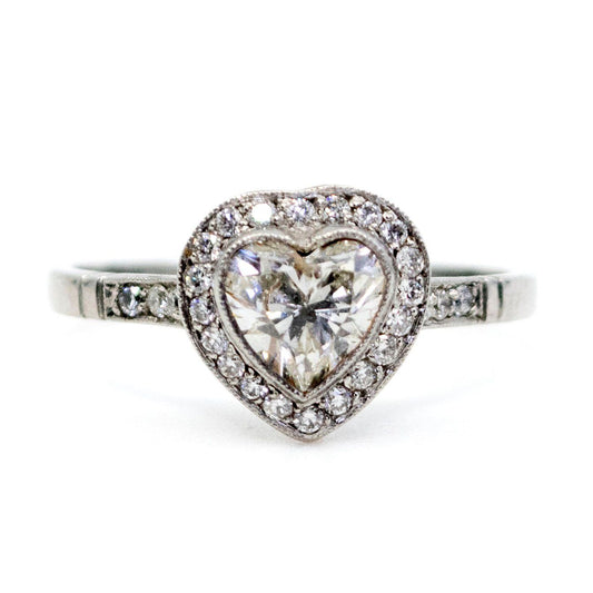 A heart shaped diamond cluster ring in platinum, with diamond shoulders