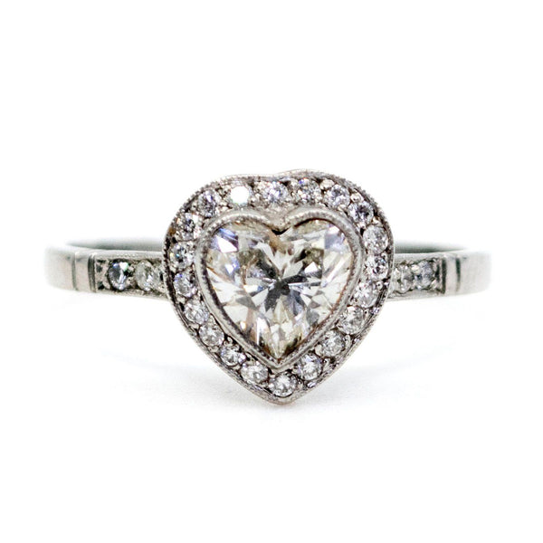 A heart shaped diamond cluster ring in platinum, with diamond shoulders
