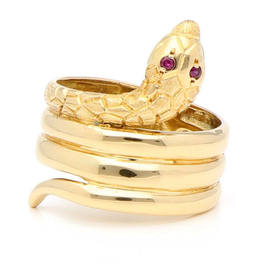 A yellow gold coiled snake ring with ruby eyes