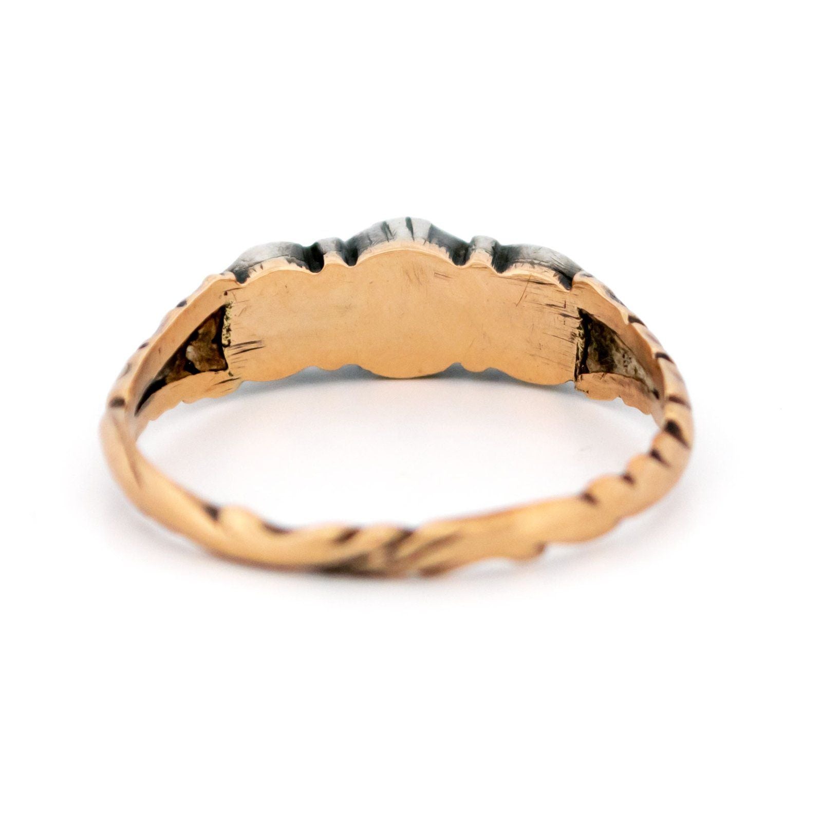 A yellow gold and silver rose cut diamond three stone ring