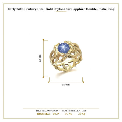 A yellow gold double snake ring holding a cabochon star sapphire in their mouths, with measurements