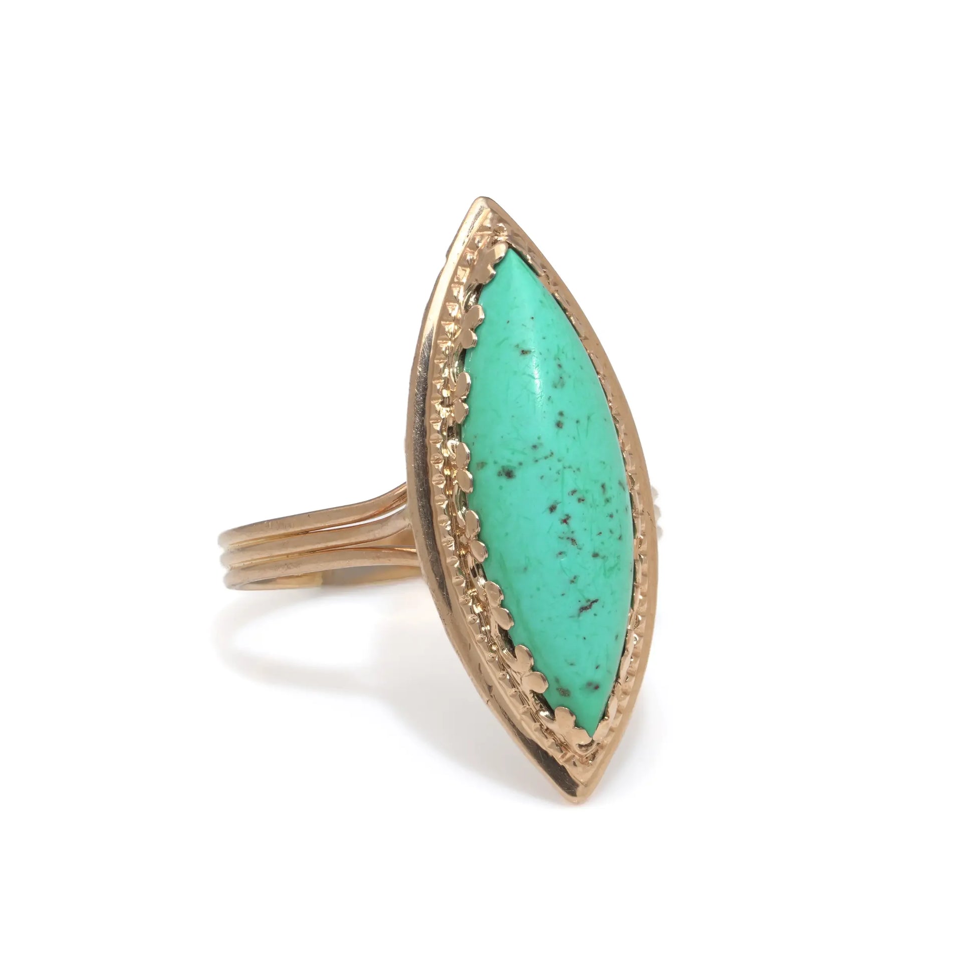 A navette shaped turquoise single stone ring in yellow gold