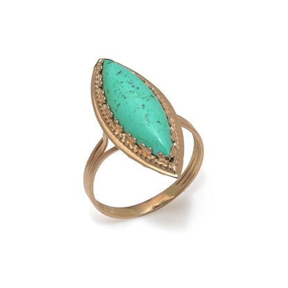 A navette shaped turquoise single stone ring in yellow gold