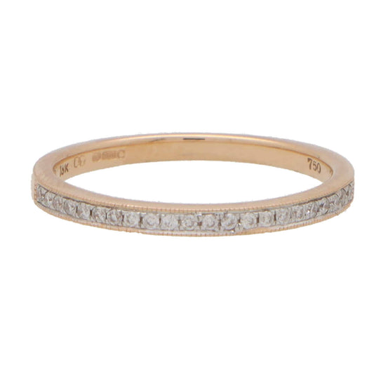 A rose gold diamond set half eternity band ring, stamped 18K 750, on a white background