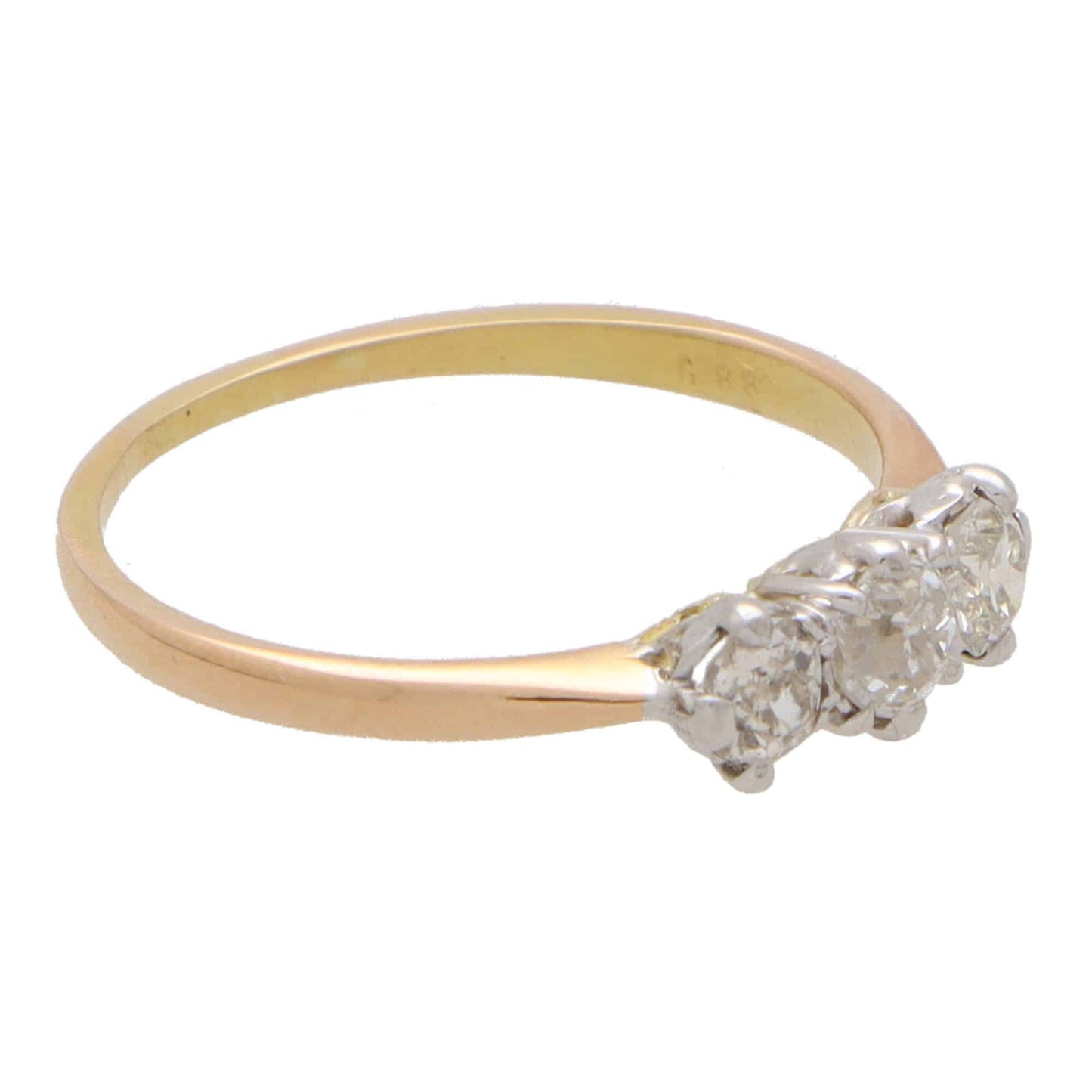 Vintage three stone diamond ring set in yellow and rose gold.