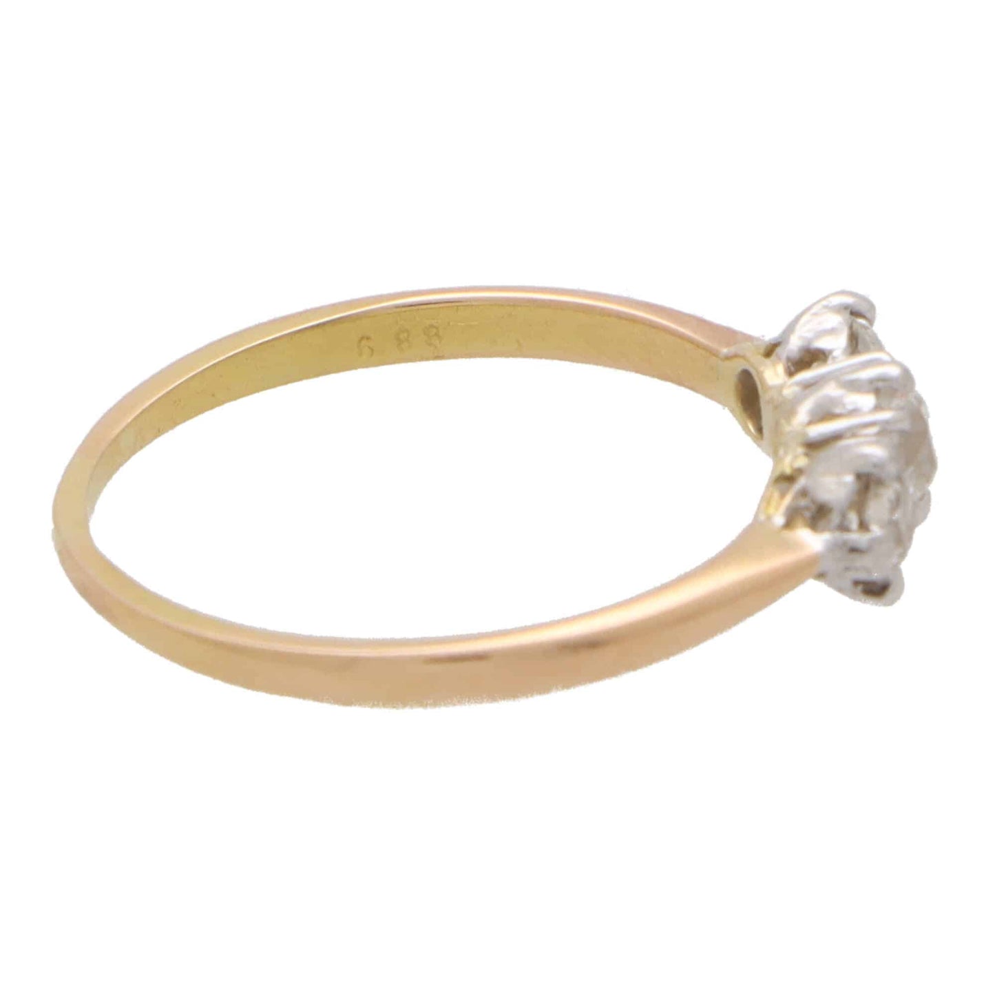 Vintage three stone diamond ring set in yellow and rose gold.