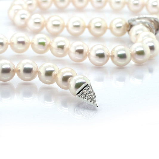 A pearl necklace with a white gold diamond set clasp