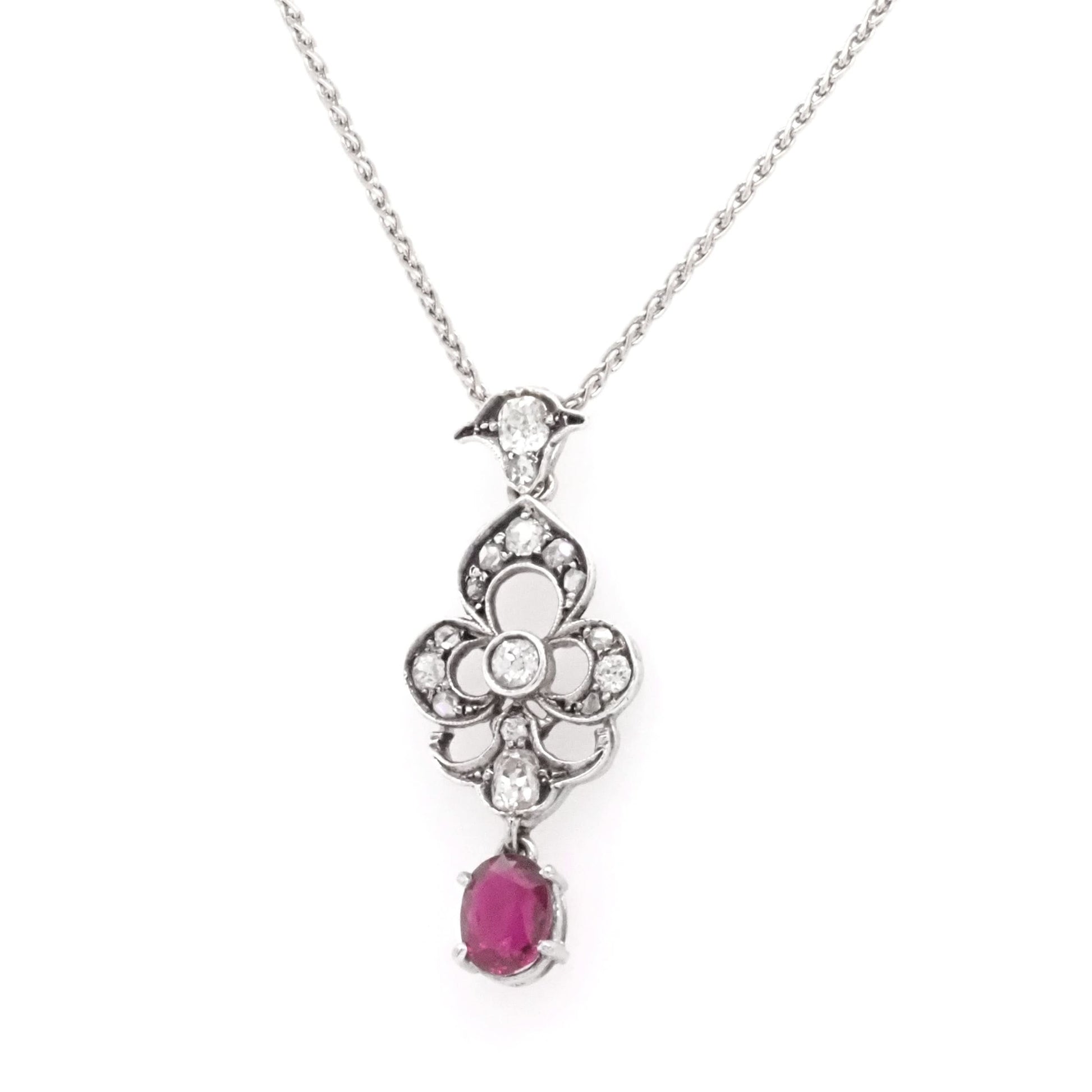 A ruby and diamond white gold pendant with chain