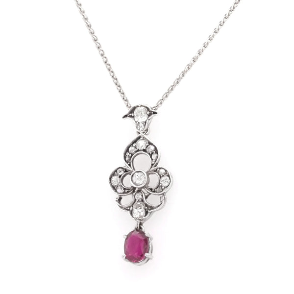 A ruby and diamond white gold pendant with chain
