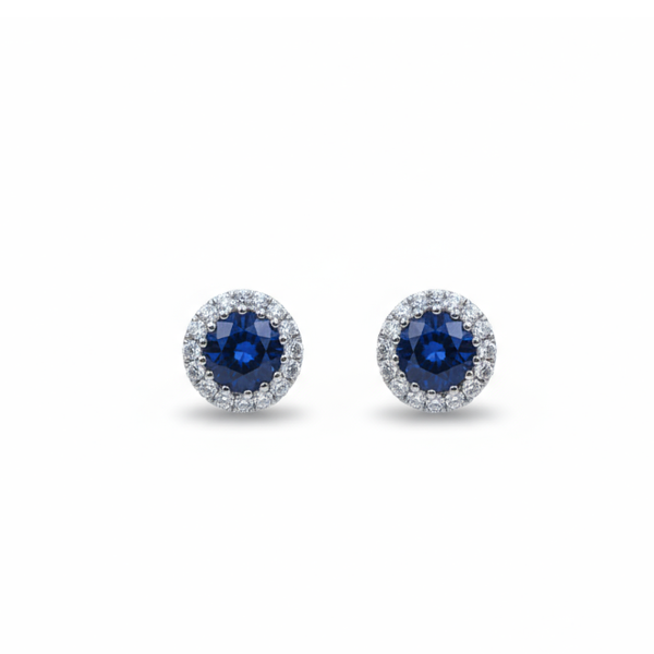 A pair of round cluster stud earrings in white gold with sapphires and diamonds