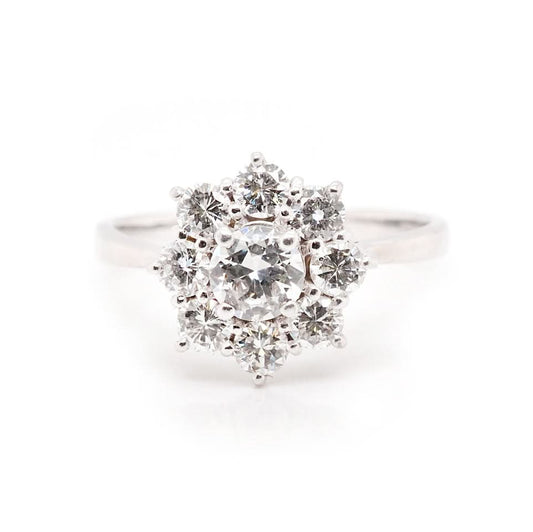A white gold round cut diamond floral cluster ring