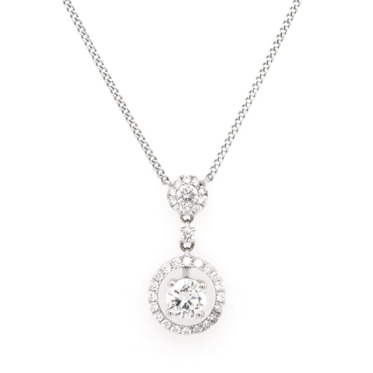 A white gold diamond double cluster drop pendant necklace, on an integrated chain
