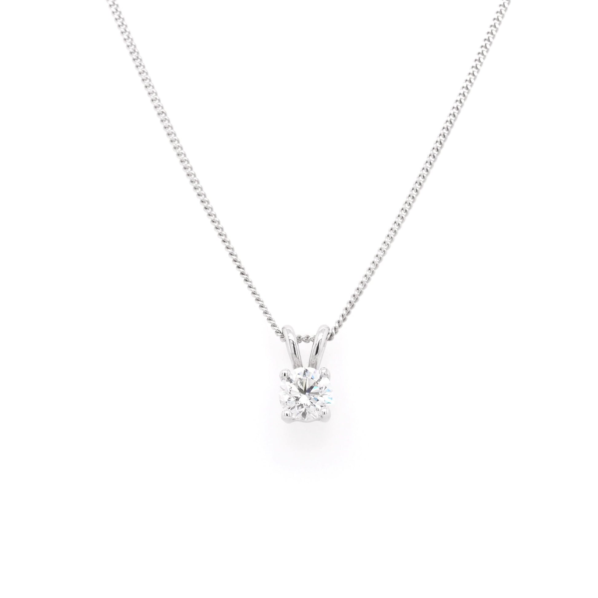 A single stone round brilliant cut diamond pendant in white gold, on a white gold curb chain