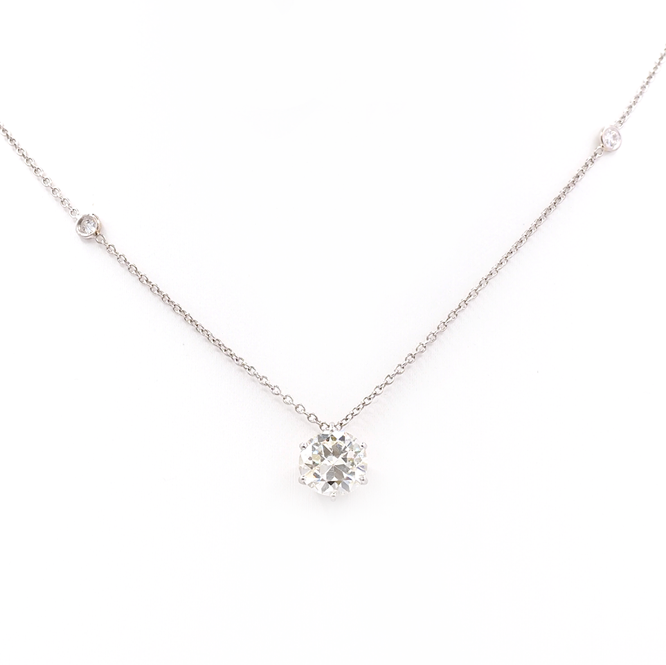 An old cut diamond pendant on a platinum diamond set chain