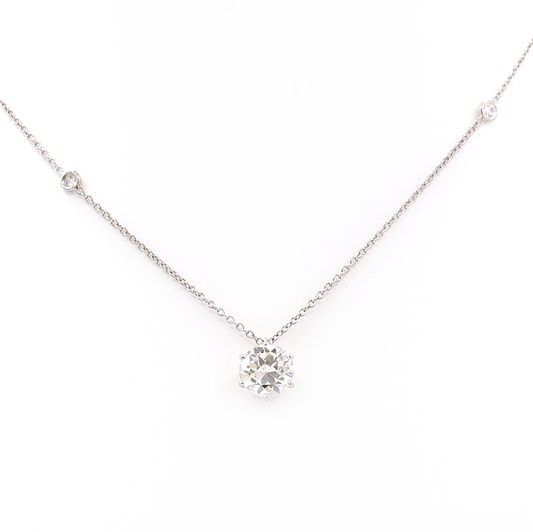 An old cut diamond pendant on a platinum diamond set chain