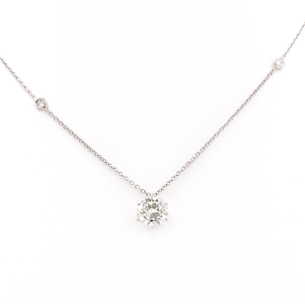 An old cut diamond pendant on a platinum diamond set chain