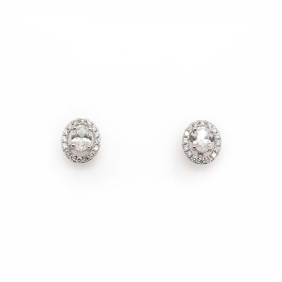 An oval pair of diamond earrings with removeable halo surrounds, in white gold