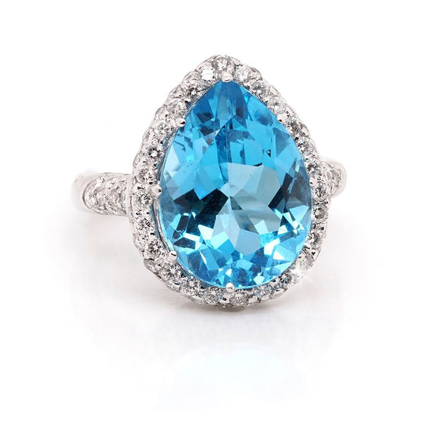 A pear shaped blue topaz and diamond cluster ring in white gold