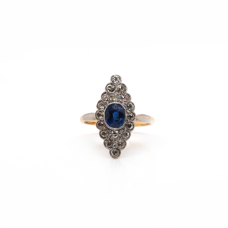 A navette cluster ring set with a central sapphire and diamond surround