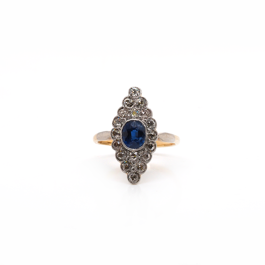 A navette cluster ring set with a central sapphire and diamond surround