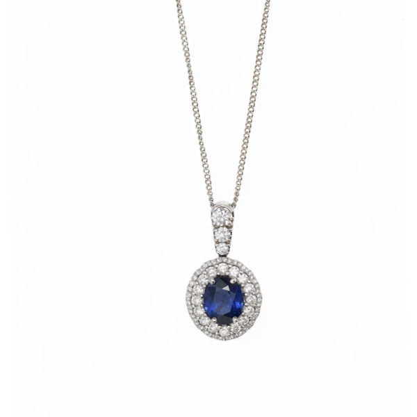 An oval cluster pendant with a sapphire centre and diamond surround, in white gold, with a white gold chain
