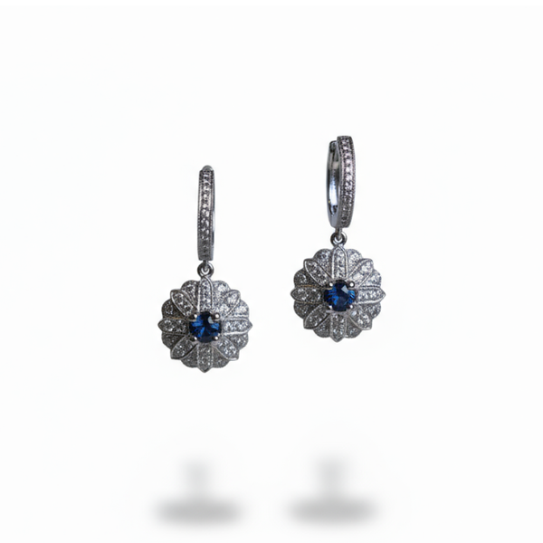 A pair of cluster drop earrings in white gold with sapphires and diamonds