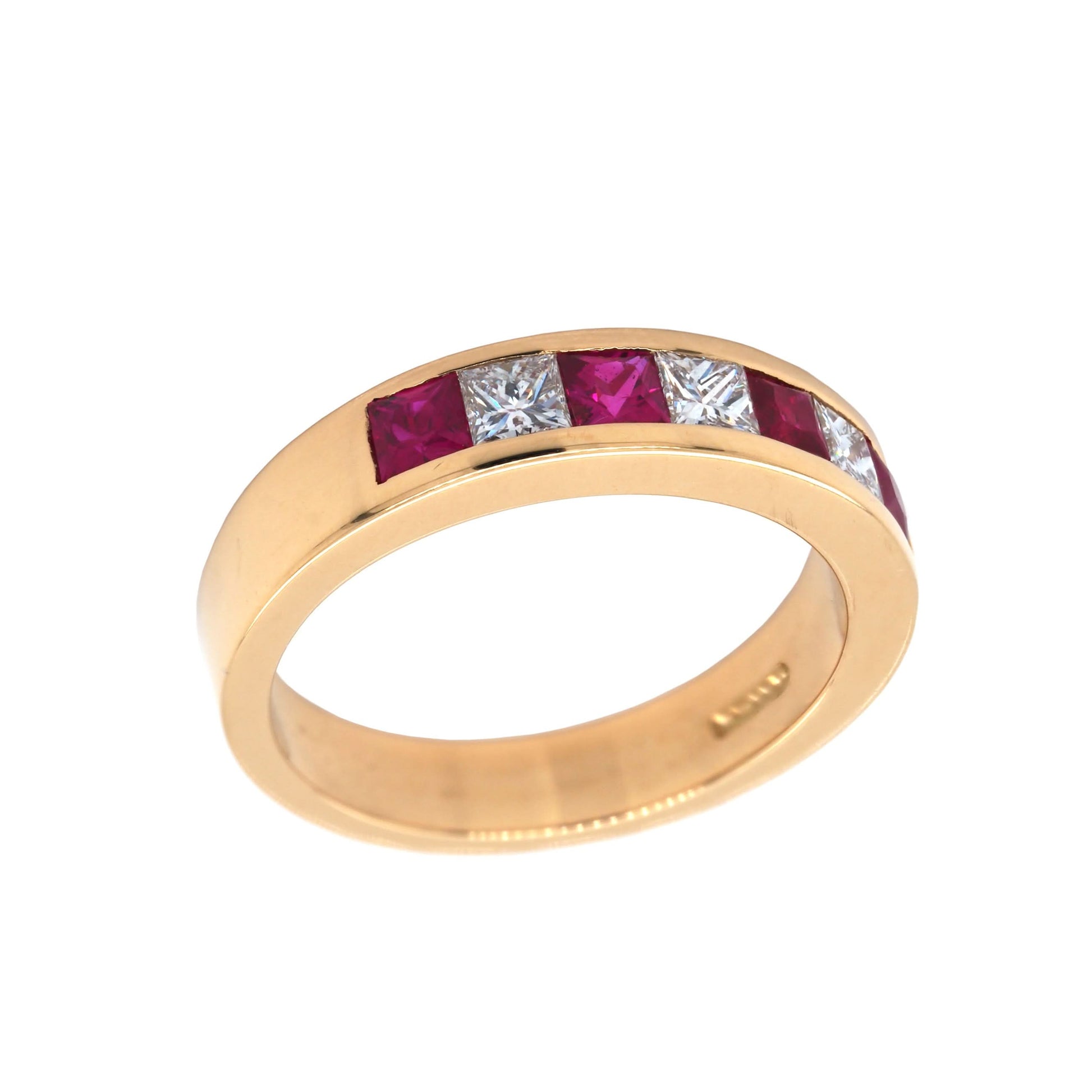 A yellow gold ruby and diamond channel set half eternity ring