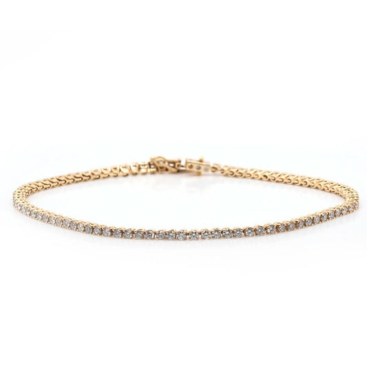 A yellow gold line bracelet set with brilliant cut diamonds