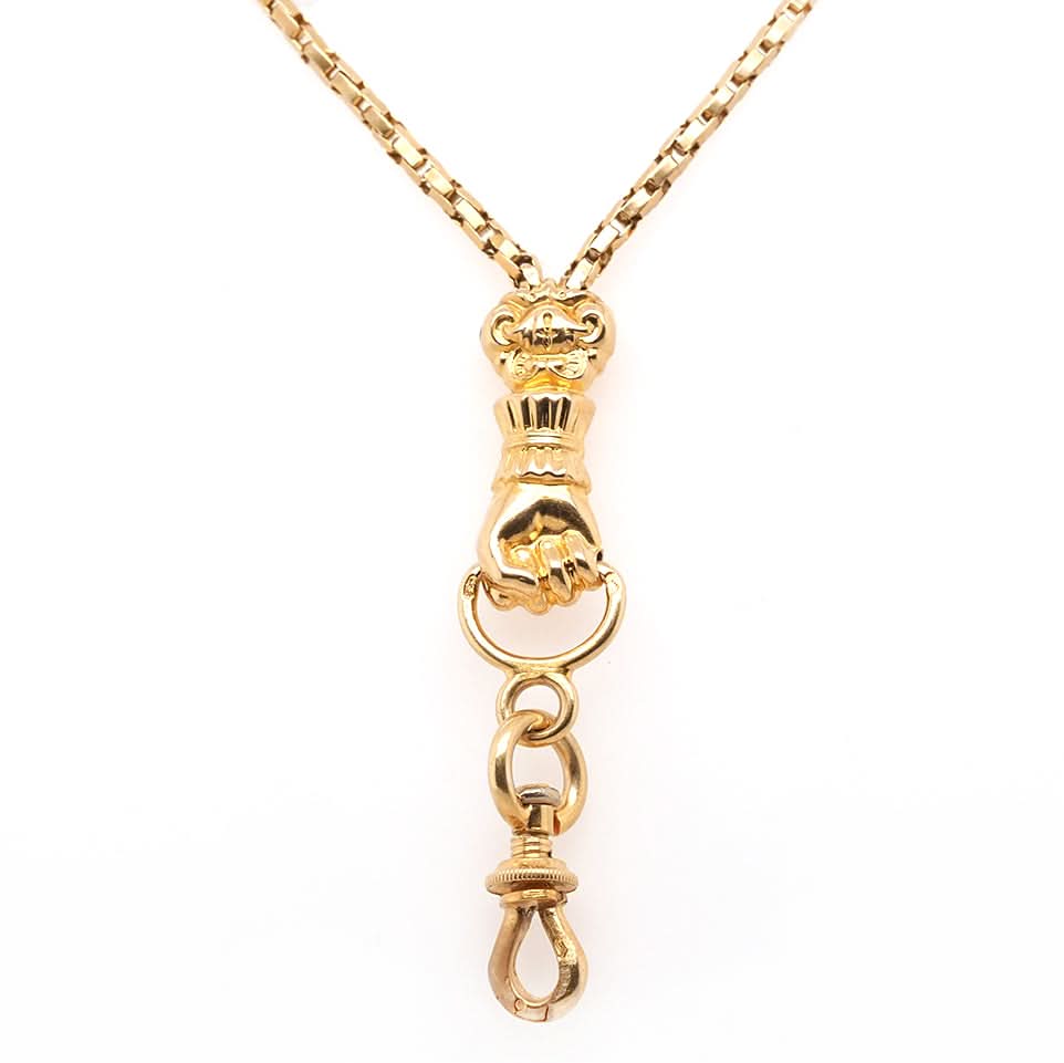 A yellow gold chain necklace with a clasped hand pendant and clasp drop