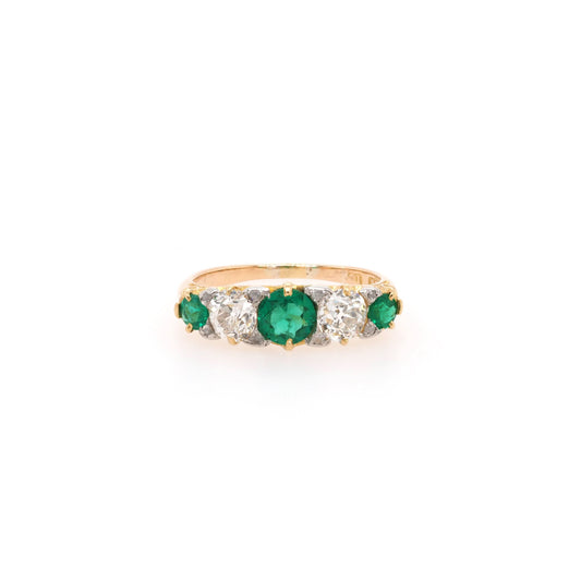 A yellow gold graduated ring with three emeralds and two diamonds