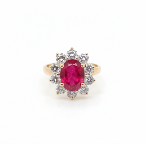 A yellow gold ruby and diamond oval cluster ring