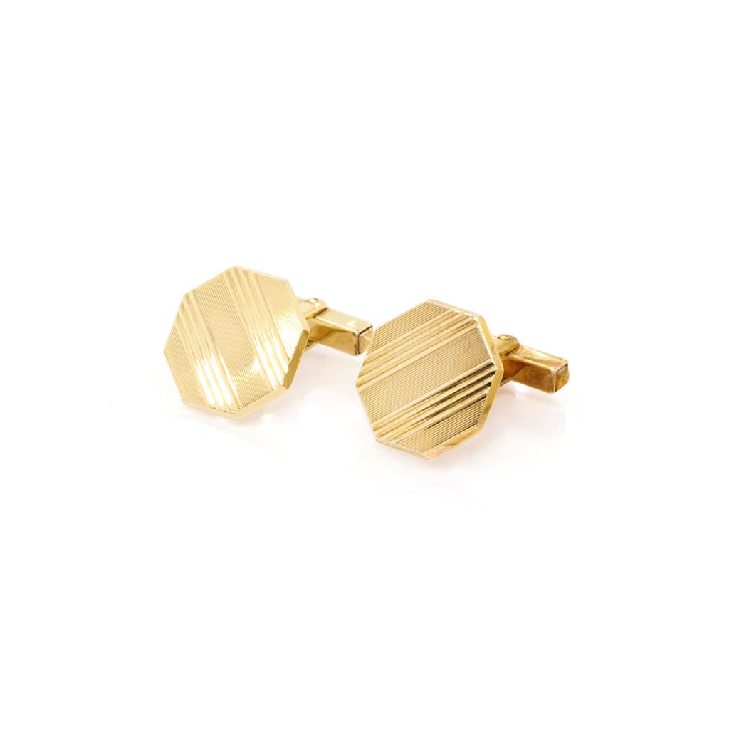 A pair of yellow gold octagonal cufflinks with striped patterns